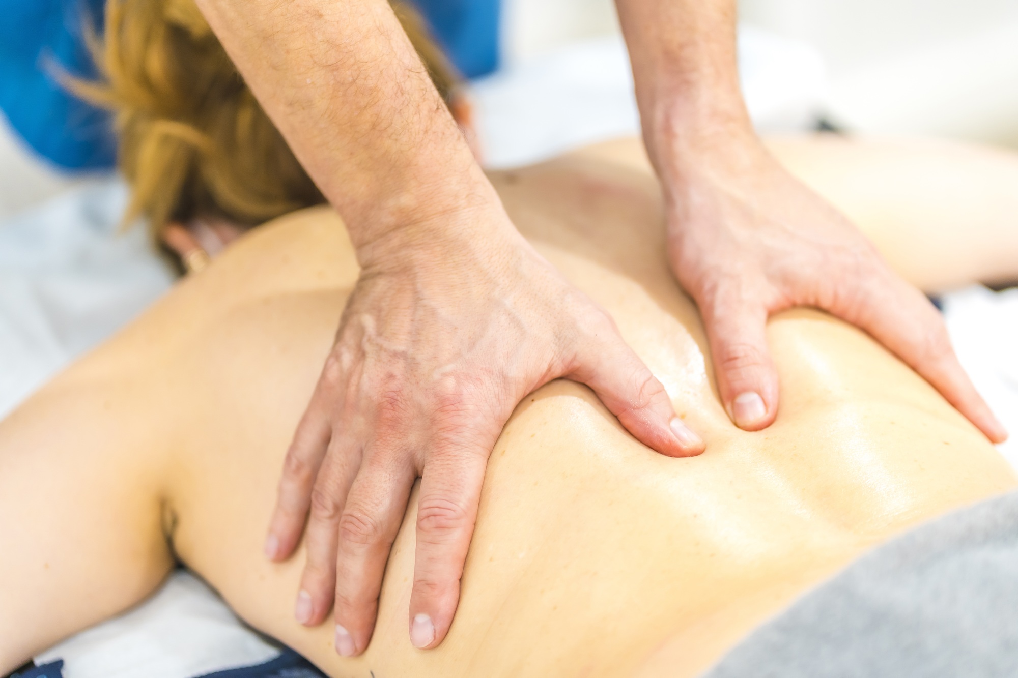 Physiotherapist giving neck and back Chiromassage to a female patient